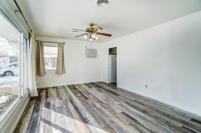 spare room with hardwood / wood-style flooring and ceiling fan