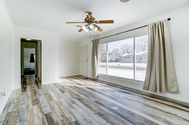 spare room with ceiling fan and light wood-type flooring