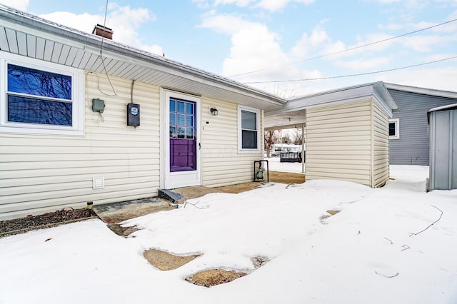 view of snow covered property entrance