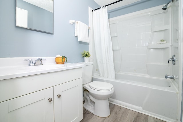 full bathroom with toilet, hardwood / wood-style floors, shower / bath combination with curtain, a textured ceiling, and vanity