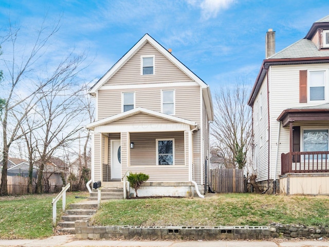 view of property with a porch and a front lawn