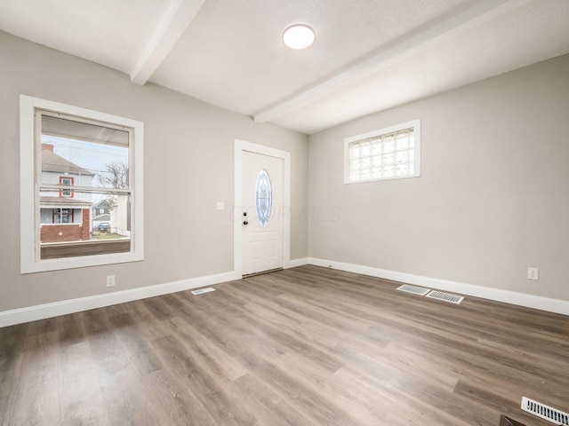 foyer with beamed ceiling and hardwood / wood-style flooring