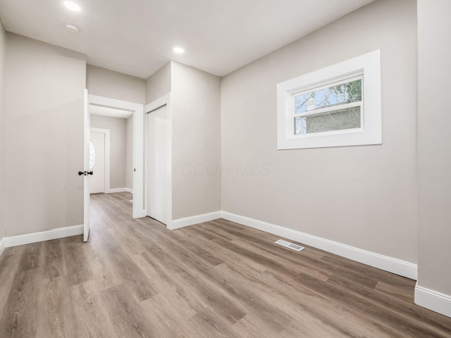 empty room with hardwood / wood-style flooring