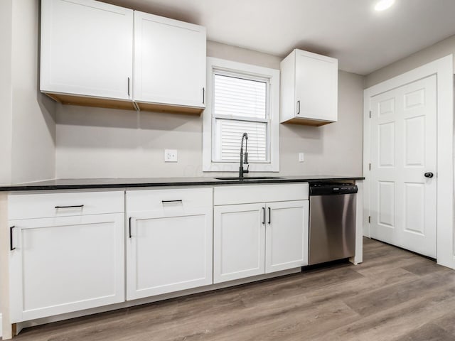 kitchen with light hardwood / wood-style floors, dishwasher, sink, and white cabinets