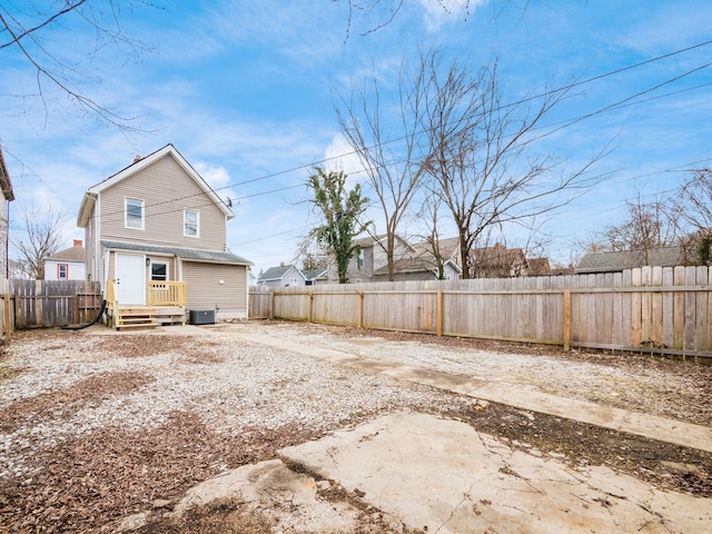 back of house with central AC