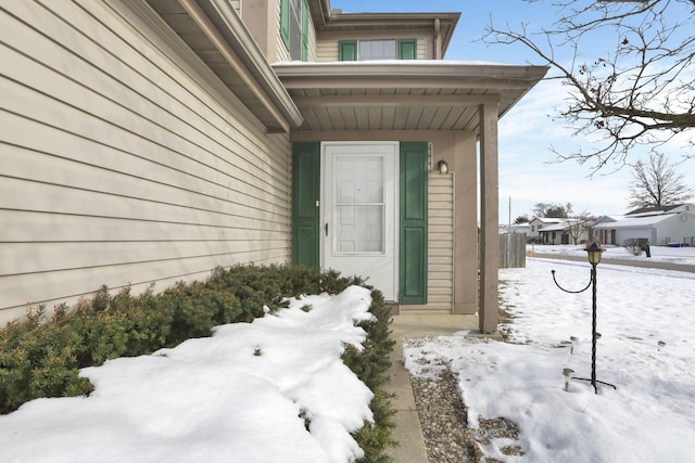 view of snow covered property entrance