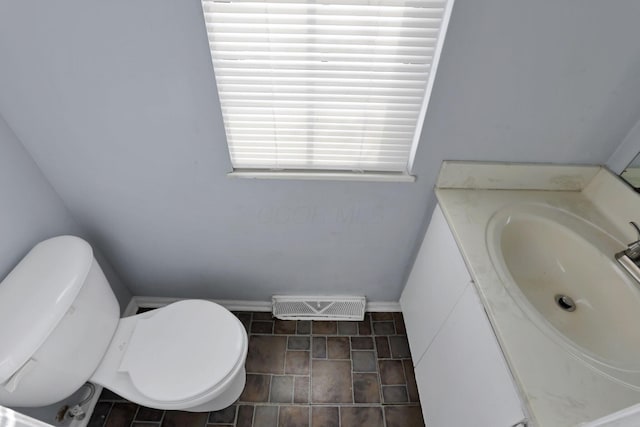 bathroom featuring toilet and vanity