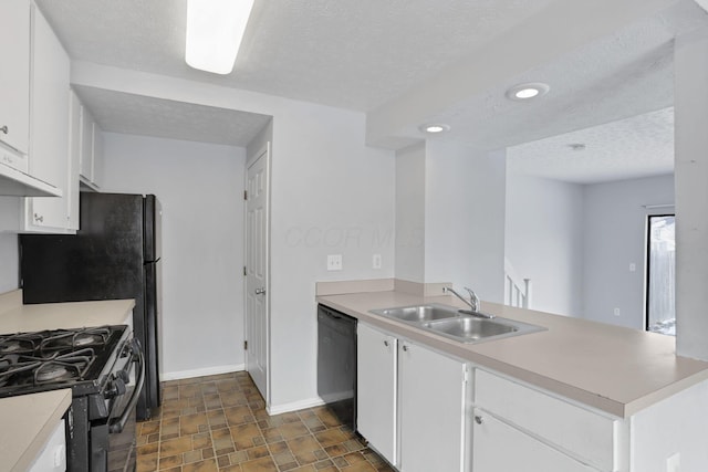 kitchen with white cabinetry, kitchen peninsula, sink, a textured ceiling, and black appliances