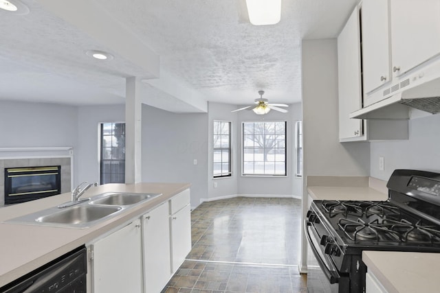 kitchen with sink, a textured ceiling, white cabinets, and black appliances