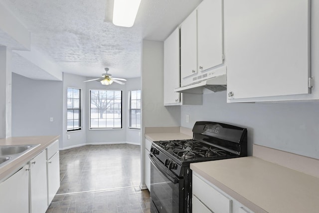 kitchen with a textured ceiling, ceiling fan, white cabinets, and black gas stove