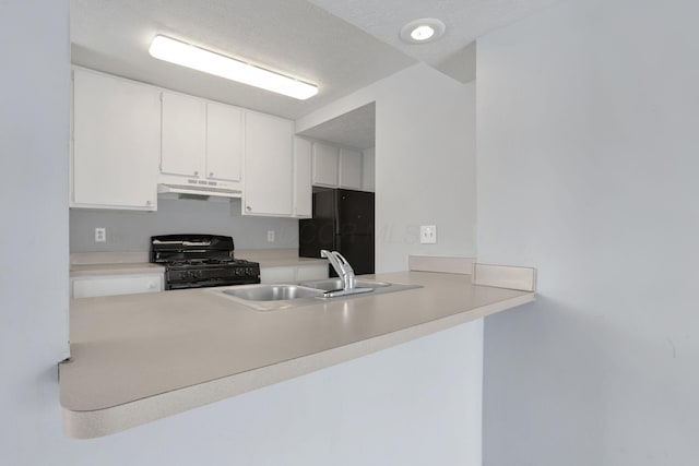 kitchen featuring a textured ceiling, white cabinetry, sink, and black appliances