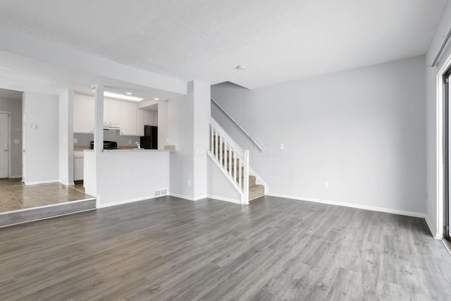 unfurnished living room with hardwood / wood-style floors