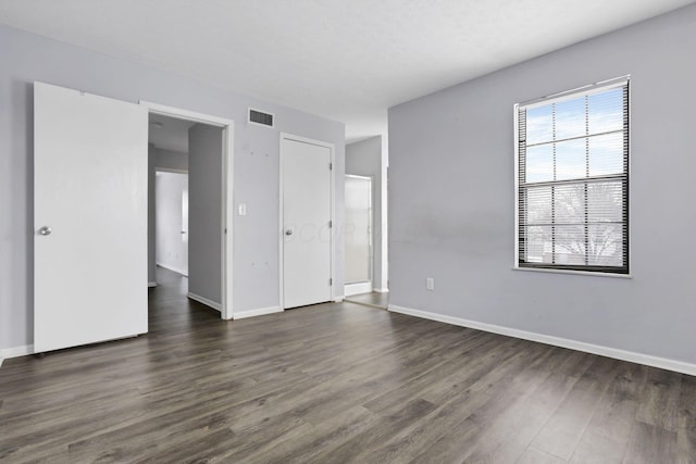 unfurnished bedroom featuring dark wood-type flooring