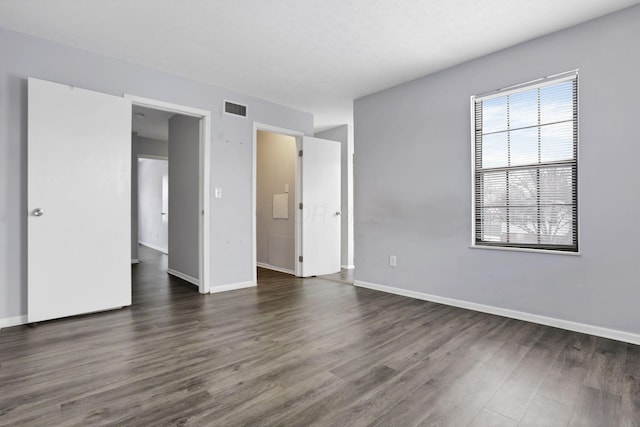 unfurnished bedroom with dark hardwood / wood-style flooring