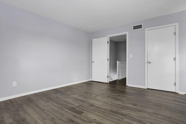 unfurnished bedroom featuring dark hardwood / wood-style floors