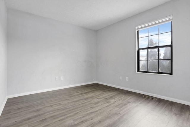 empty room with hardwood / wood-style floors