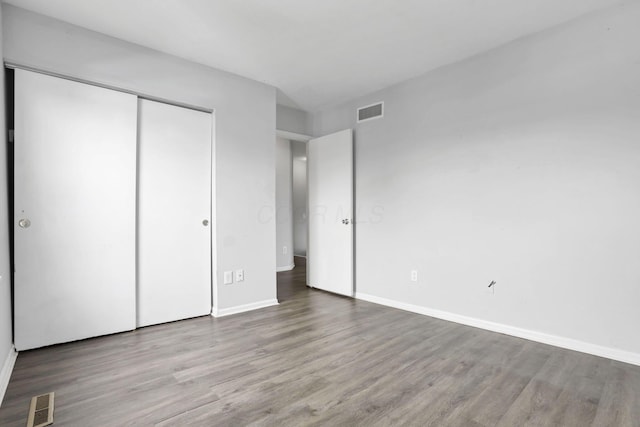 unfurnished bedroom with a closet and light hardwood / wood-style flooring