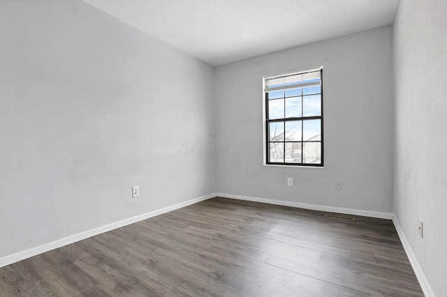 empty room featuring dark hardwood / wood-style flooring