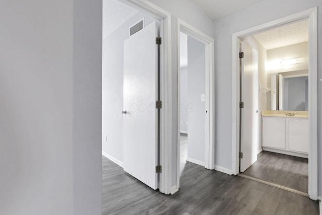 hallway with dark hardwood / wood-style floors