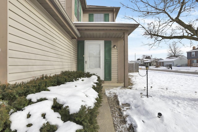 view of snow covered property entrance