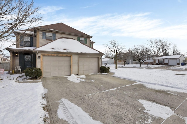 snow covered property featuring a garage