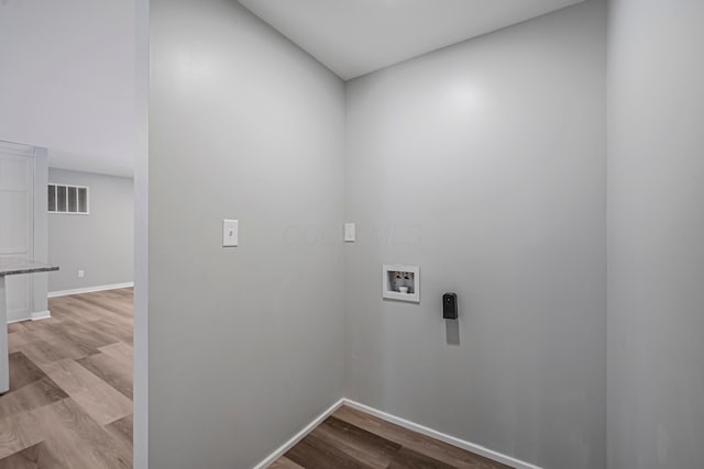 laundry area featuring washer hookup and light hardwood / wood-style floors