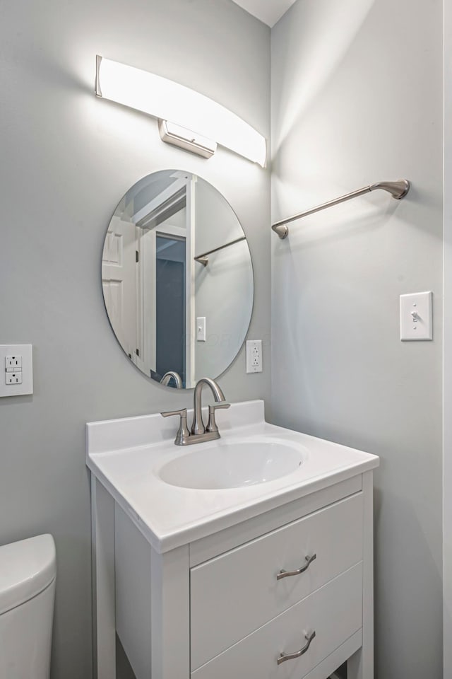 bathroom featuring toilet and vanity