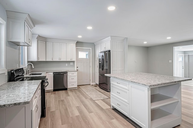 kitchen featuring dishwashing machine, white cabinets, a center island, stainless steel fridge with ice dispenser, and black electric range