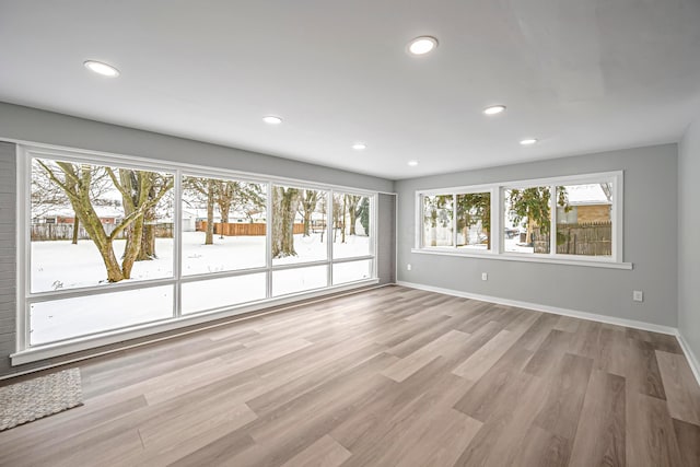 empty room featuring light wood-type flooring and a wealth of natural light