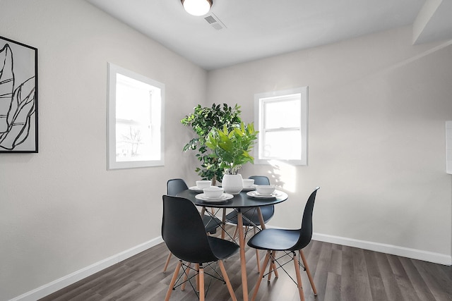 dining area with dark hardwood / wood-style floors