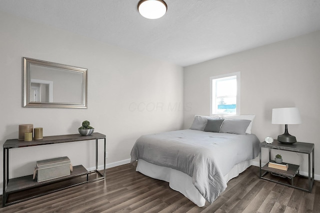 bedroom with dark hardwood / wood-style floors