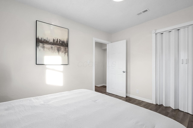 unfurnished bedroom with dark wood-type flooring