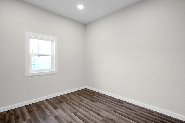 unfurnished room with dark hardwood / wood-style floors