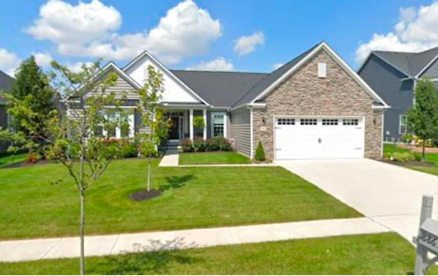 view of front of property with a garage and a front lawn