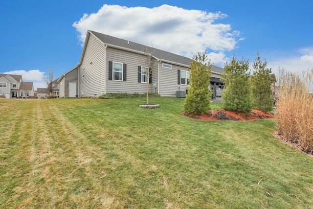 rear view of house with a yard