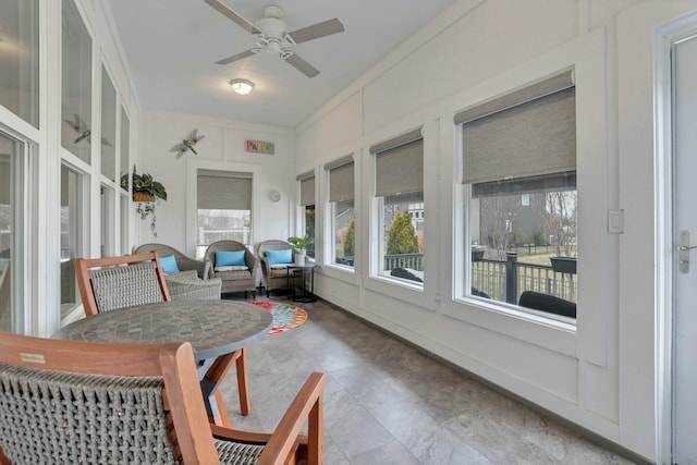 sunroom featuring ceiling fan and a wealth of natural light