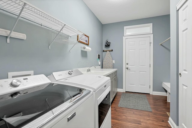 laundry room featuring cabinets, separate washer and dryer, sink, and dark hardwood / wood-style floors