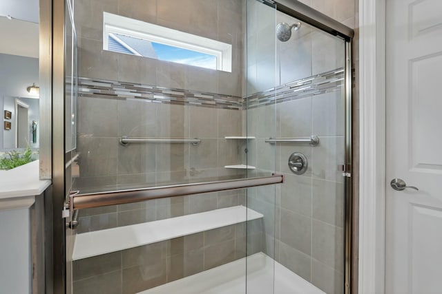 bathroom featuring a shower with shower door