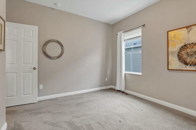 spare room featuring light colored carpet