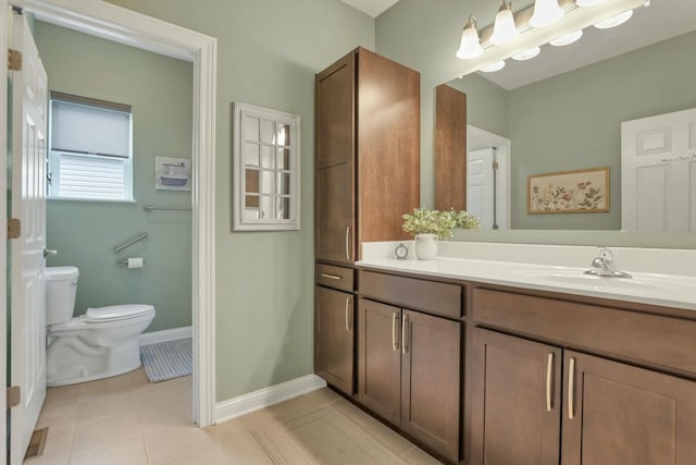 bathroom featuring vanity, tile patterned floors, and toilet