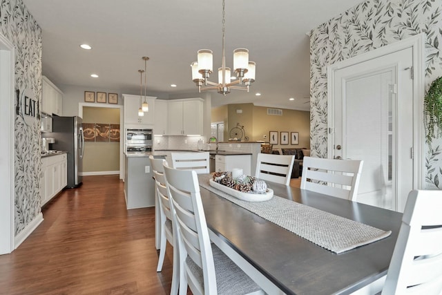 dining space featuring dark hardwood / wood-style floors, a chandelier, and sink