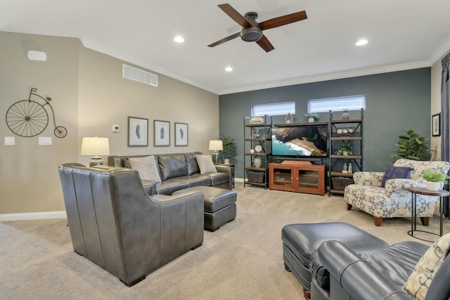 carpeted living room featuring crown molding and ceiling fan