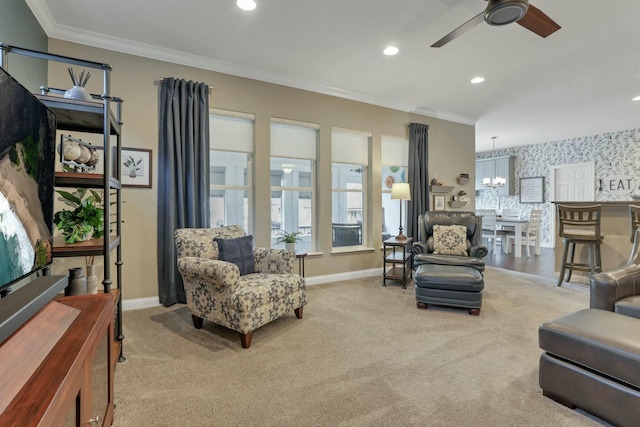 carpeted living room with crown molding and ceiling fan with notable chandelier