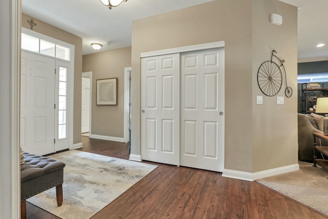 entryway with dark hardwood / wood-style flooring