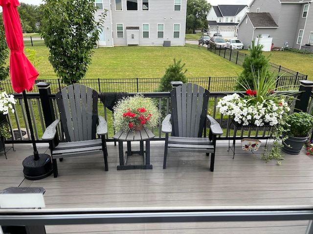 wooden terrace featuring a lawn