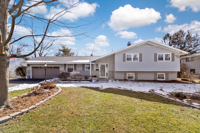 split level home featuring a porch, a garage, and a front lawn