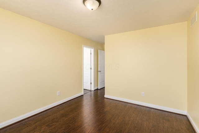 spare room featuring dark hardwood / wood-style floors