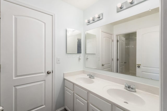 bathroom with vanity and a shower