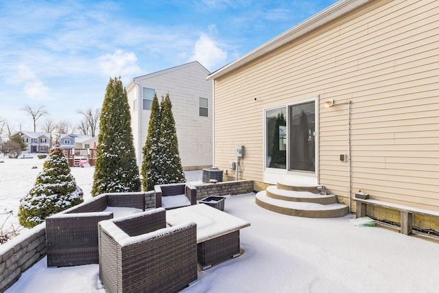 snow covered patio featuring central air condition unit