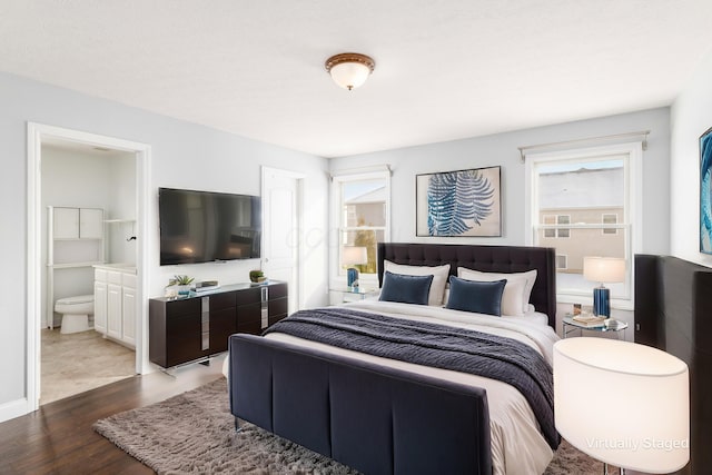 bedroom featuring hardwood / wood-style floors and ensuite bathroom